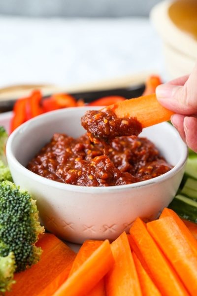 Carrot from a veggie platter being dipped in ssamjang