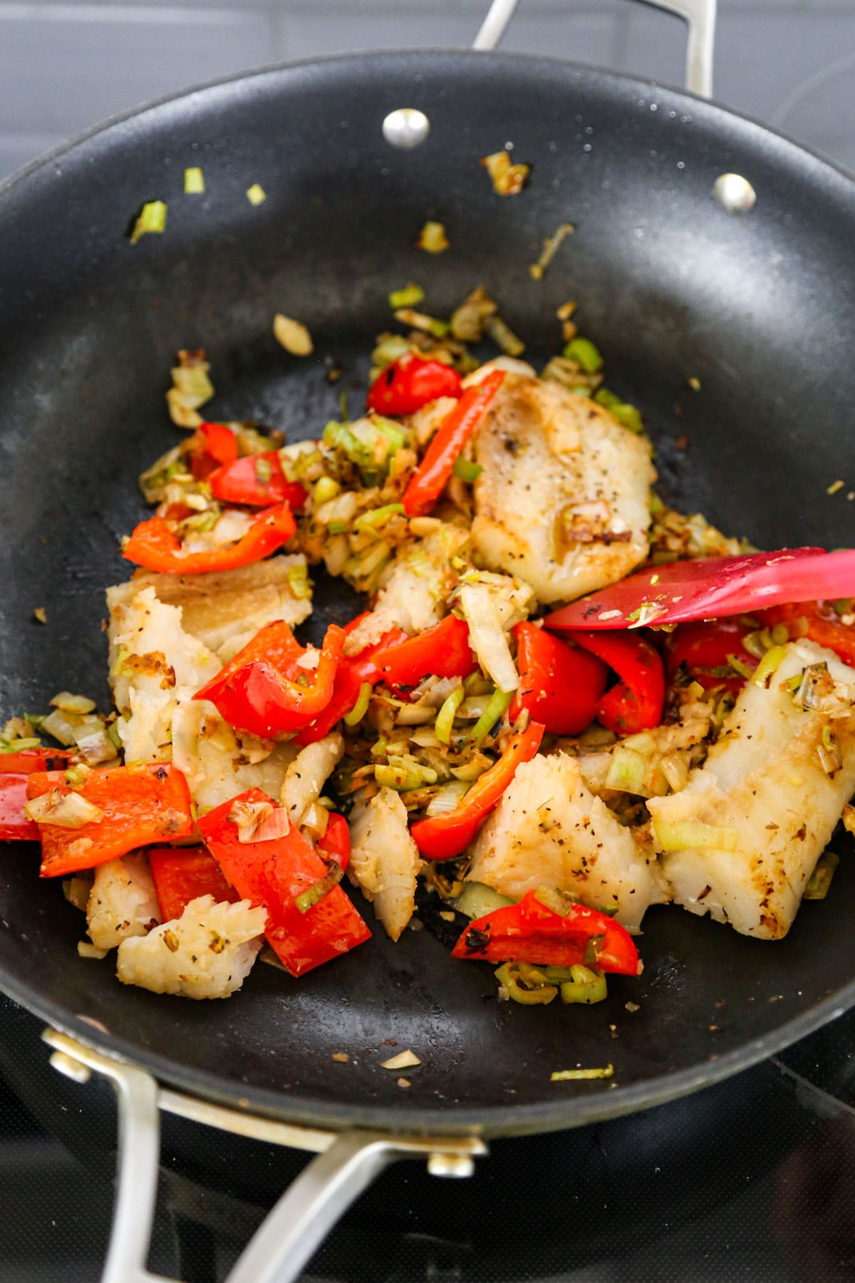 fish and bell pepper in skillet