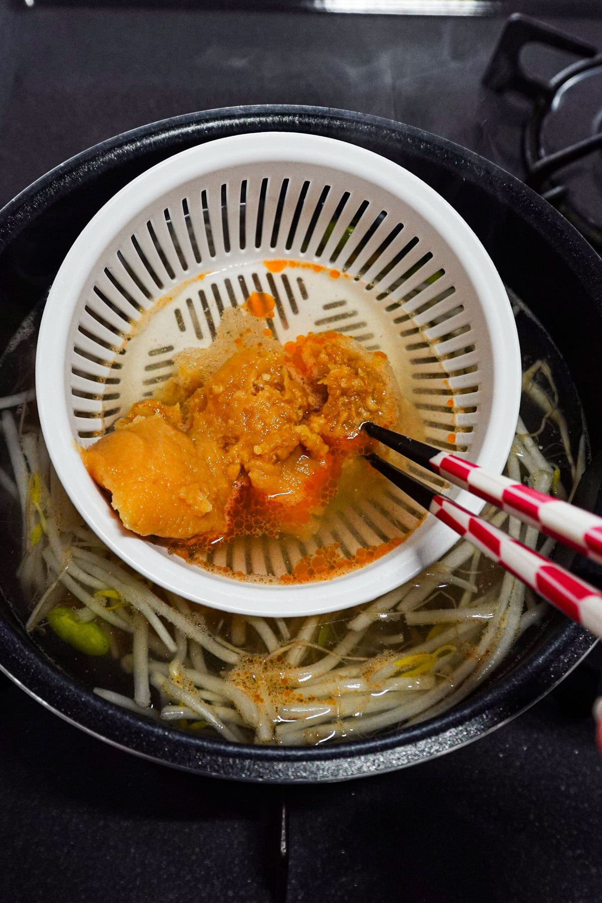 miso paste in strainer